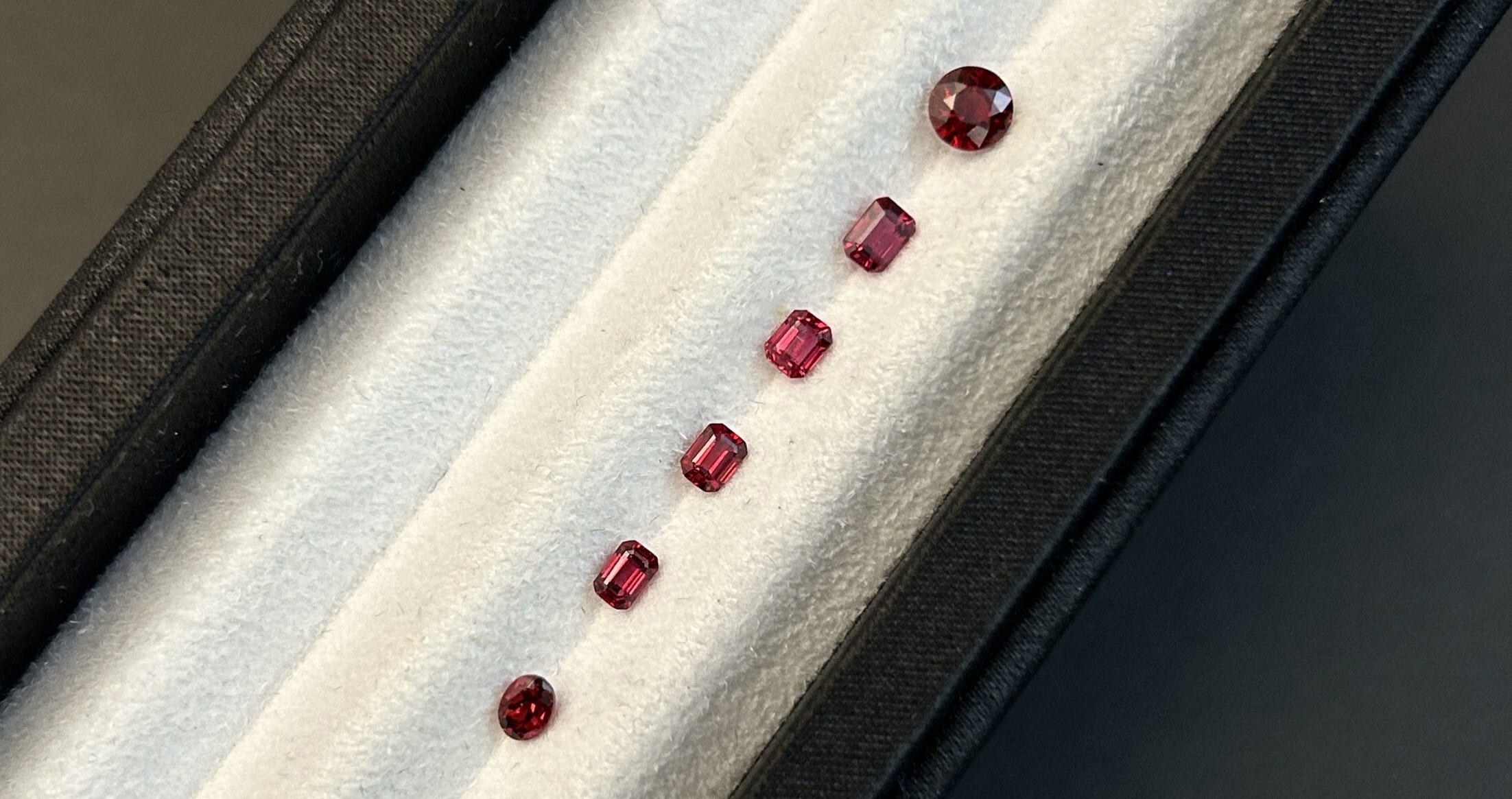 A set of intense red spinels weighing 0.24 and 0.75 carats.