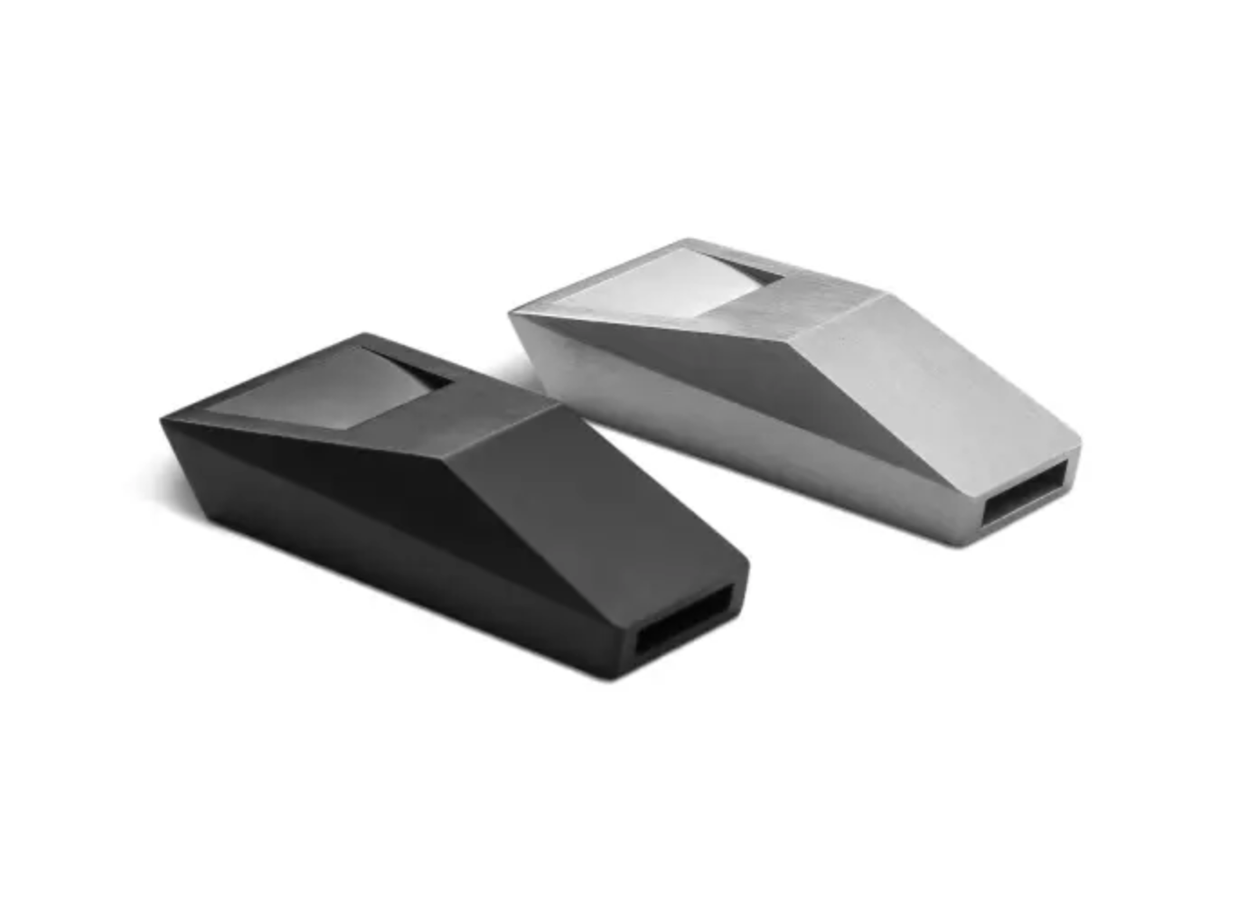 Tesla Cyberwhistle 限量哨子黑銀兩色版本，醫療級不鏽鋼製，幾何多面體切割造型取自 Cybertruck 設計語彙，尾端預留穿繩孔。