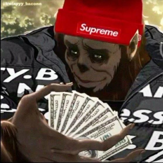 網路迷因圖，動漫風格骷髏角色戴著紅色 Supreme Logo 毛帽、手持大疊美元鈔票，嘲諷 Supreme 粉絲不惜重金搶購任何聯名商品的狂熱現象。