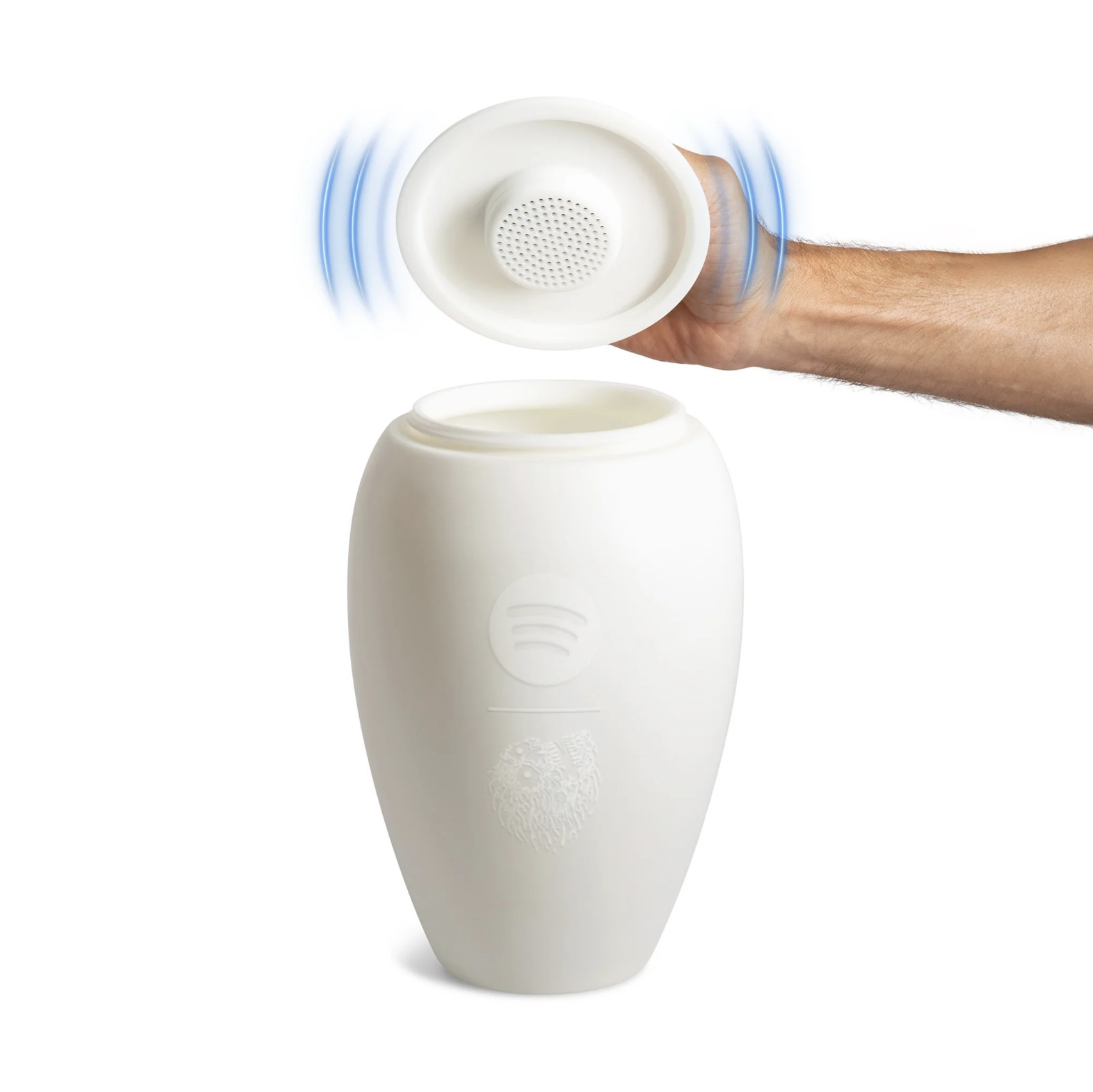 Eternal Playlist Urn 骨灰罈蓋頂拆卸示意圖，手持開蓋展示內建圓形藍牙喇叭單體，藍色音波特效呈現出音效，瓶身浮雕 Spotify 與 Liquid Death 骷髏 Logo 清晰可見。