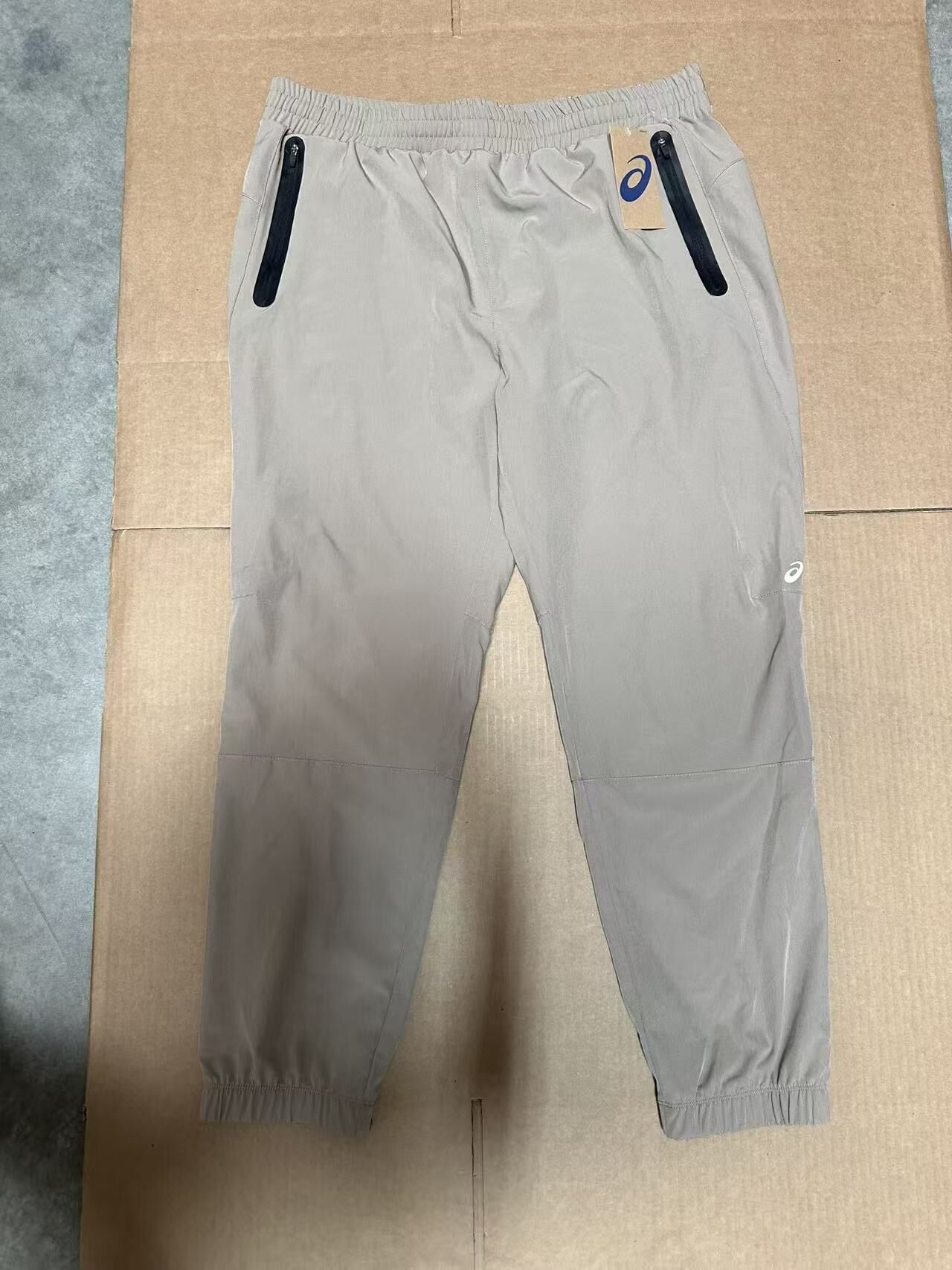 【預購】H0408129 ASICS 亞瑟士 彈性輕量防風束口運動長褲