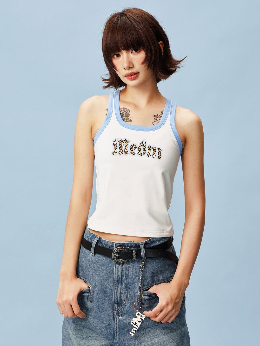 MEDM Gothic font, leopard print patch logo, color-blocked sleeveless vest