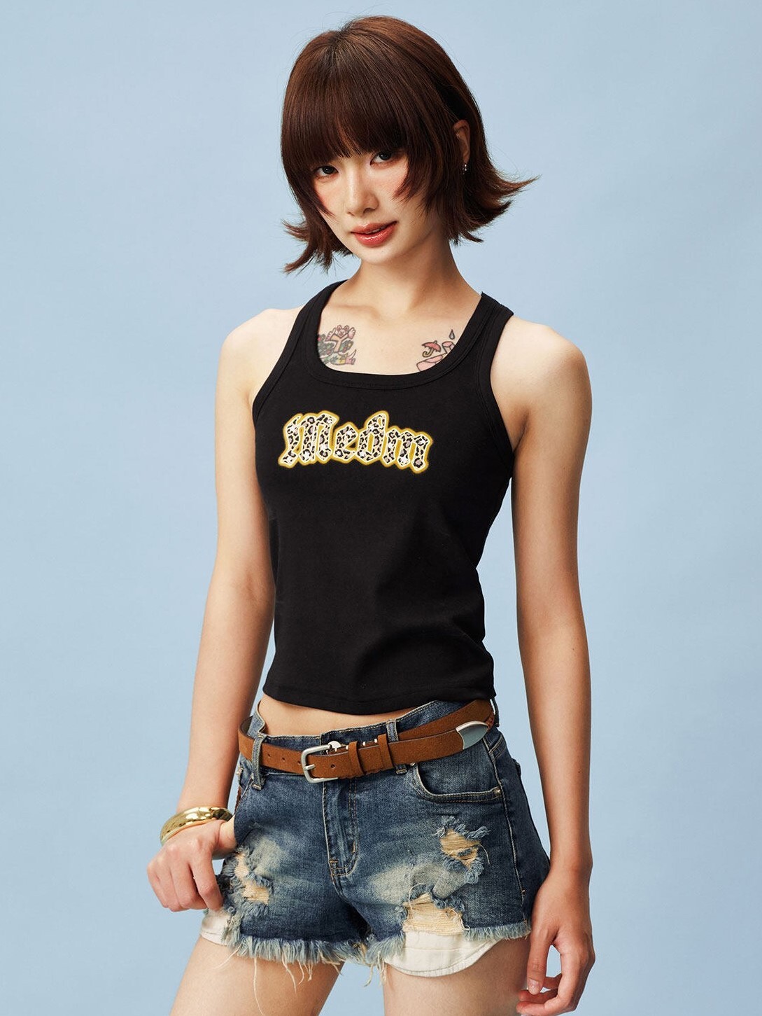 MEDM Gothic font, leopard print patch logo, color-blocked sleeveless vest