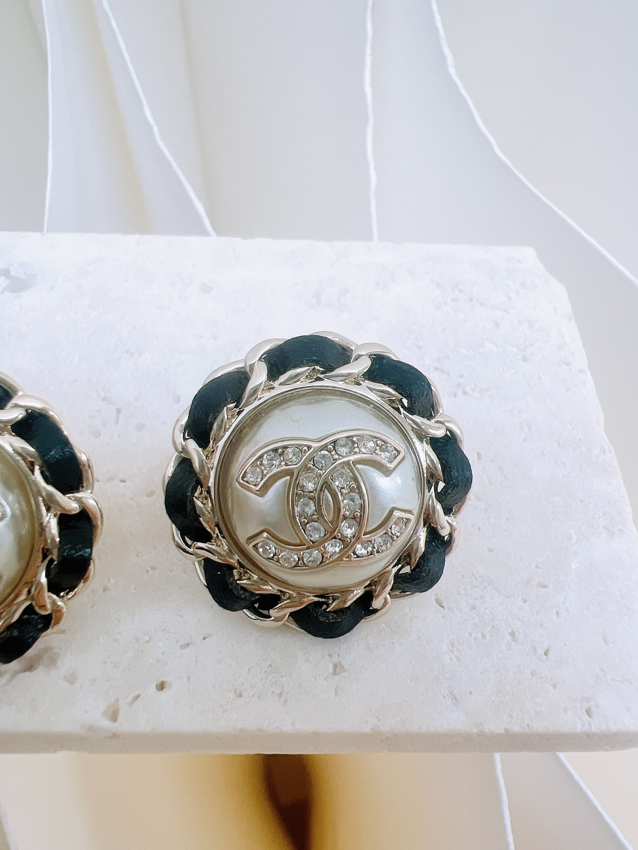 Chanel 21k round earrings black leather/ crystal logo