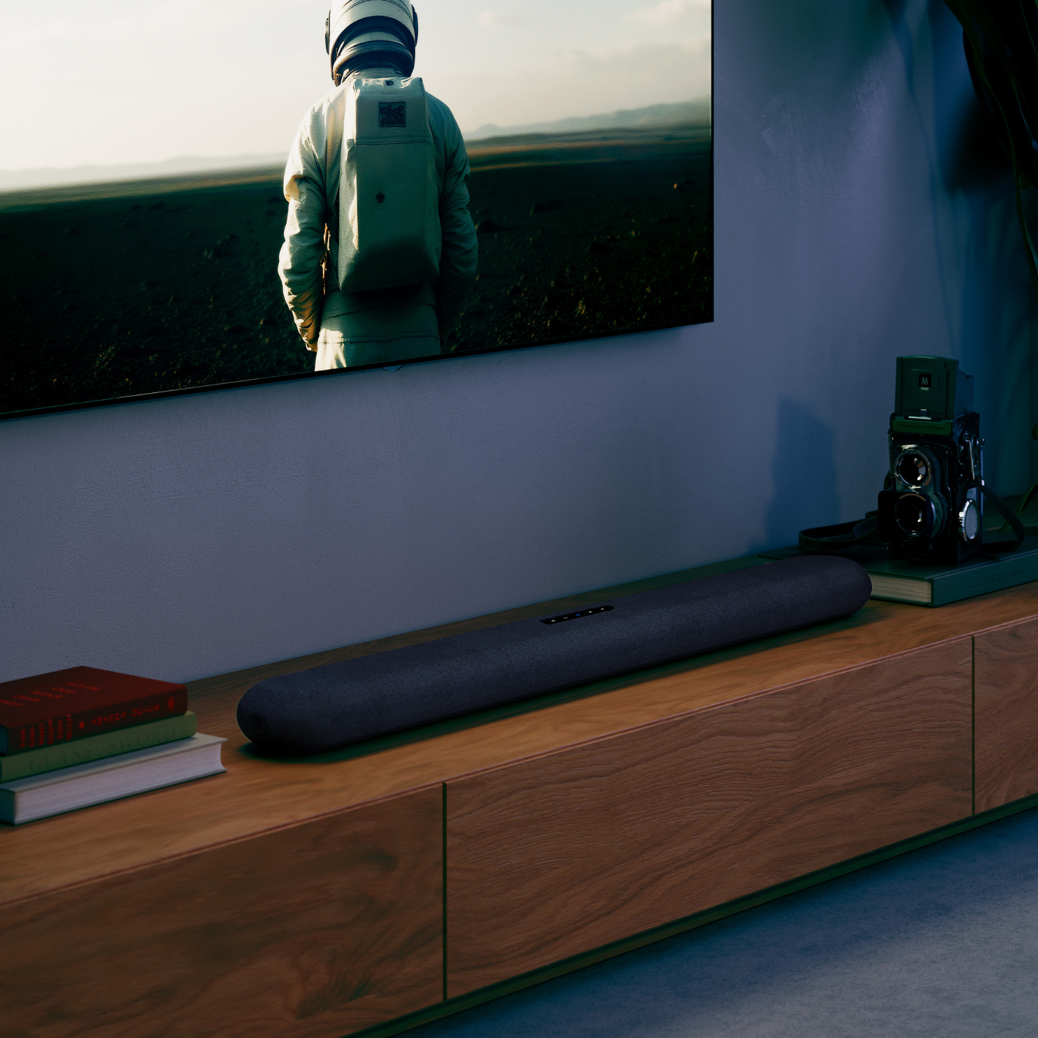 Bluesound PULSE CINEMA Soundbar on cabinet with tv