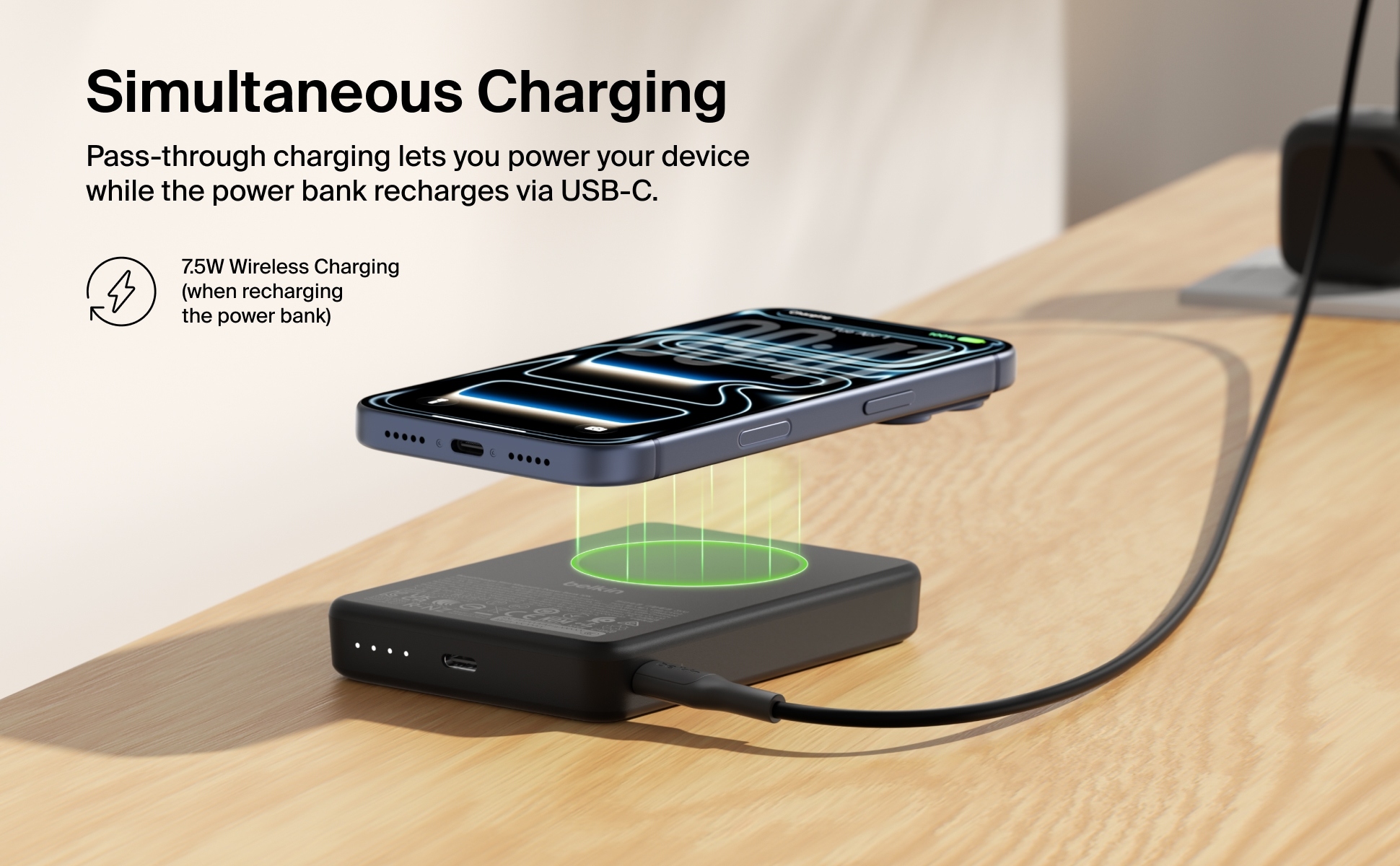 Belkin BoostCharge Slim Magnetic Power Bank 10K charging an iPhone wirelessly while connected to another device via USB-C.