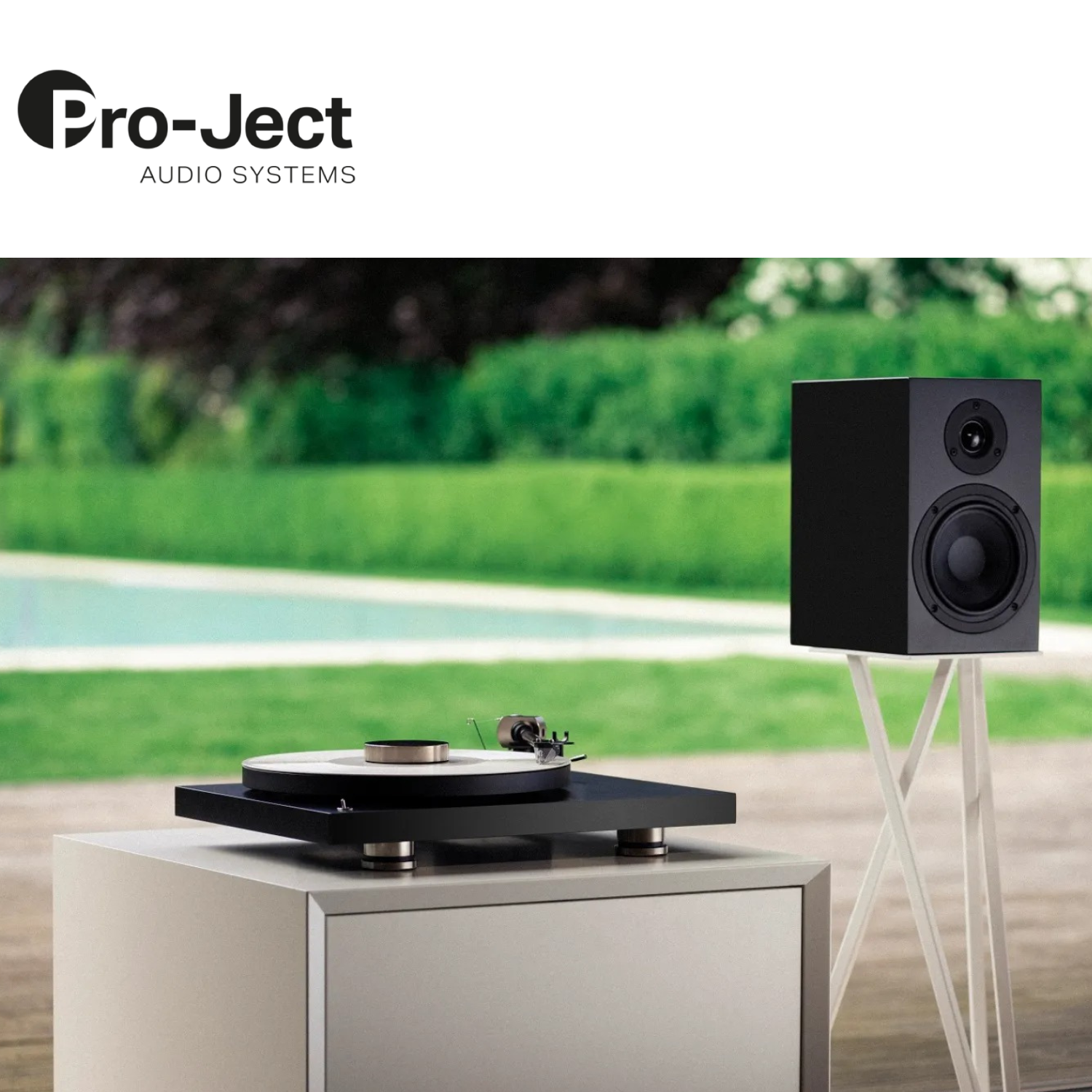 Pro-Ject Debut PRO B Turntable Black lifestyle with speaker