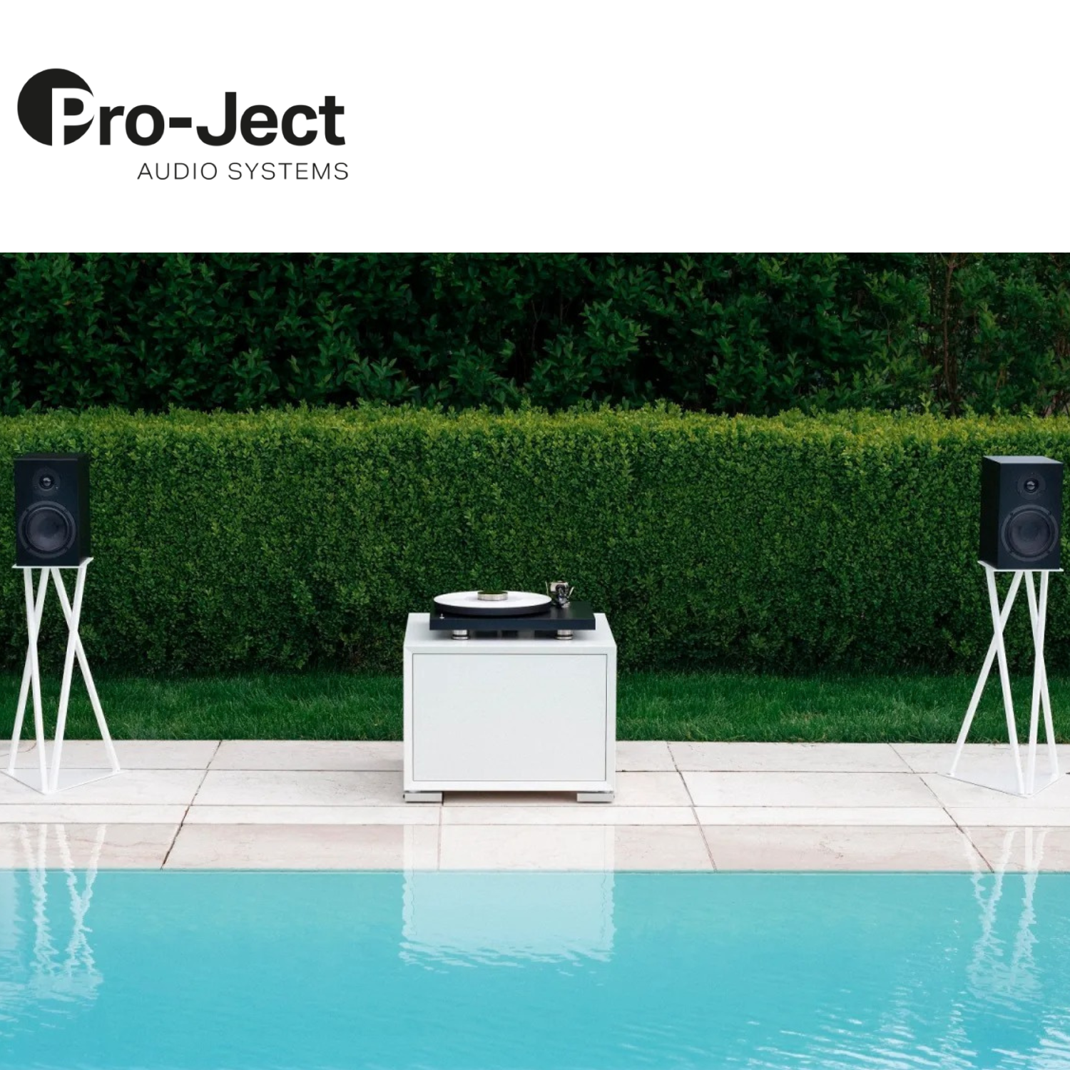 Pro-Ject Debut PRO B Turntable Black lifestyle poolside with speaker