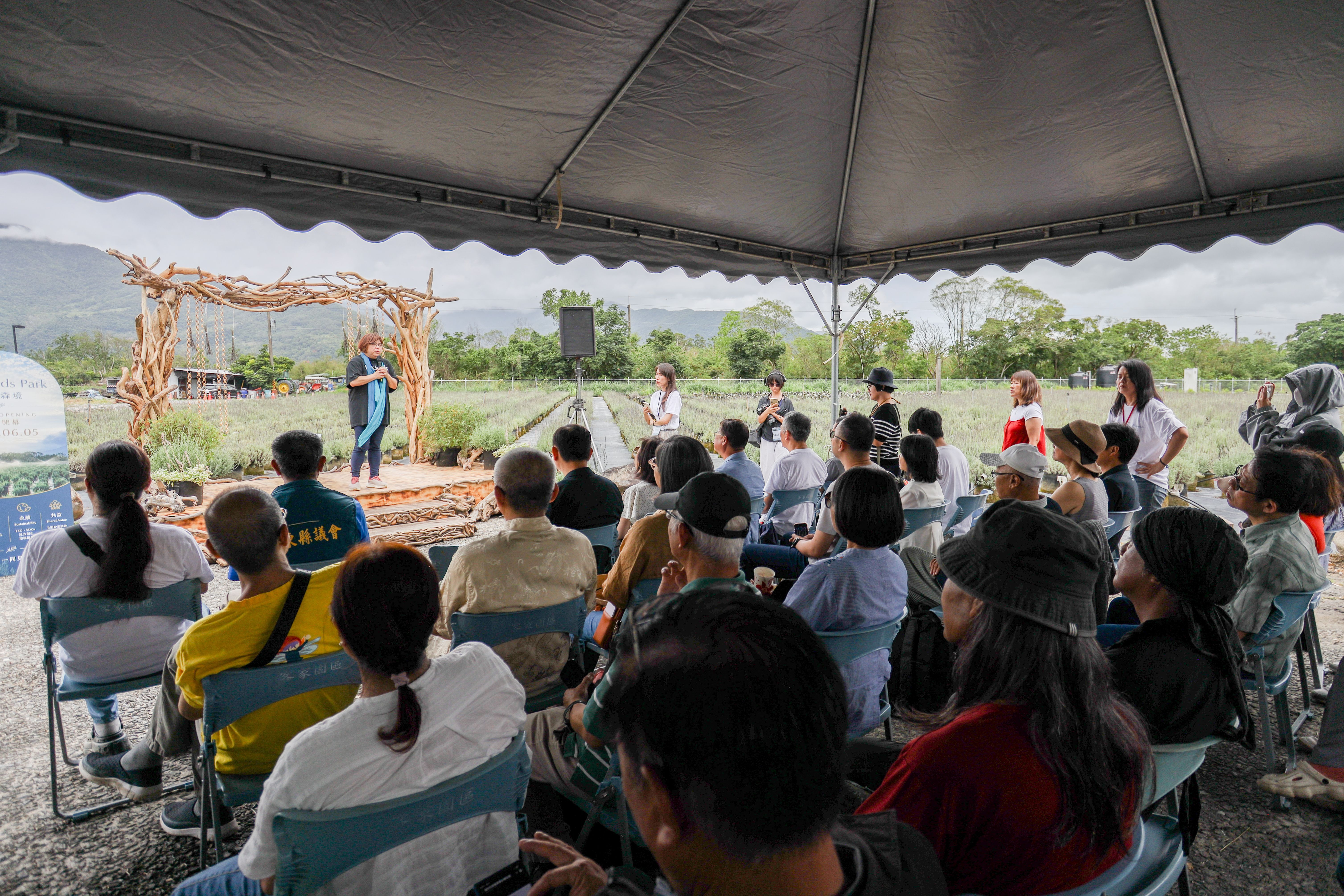 An outdoor gathering beside the lavender gardens at Blueseeds Park