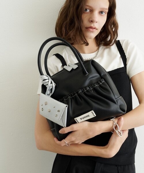 TYNNE. / Color-blocked leather bag with concho pouch