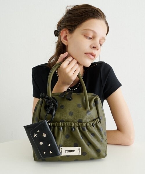 TYNNE. / Color-blocked leather bag with concho pouch