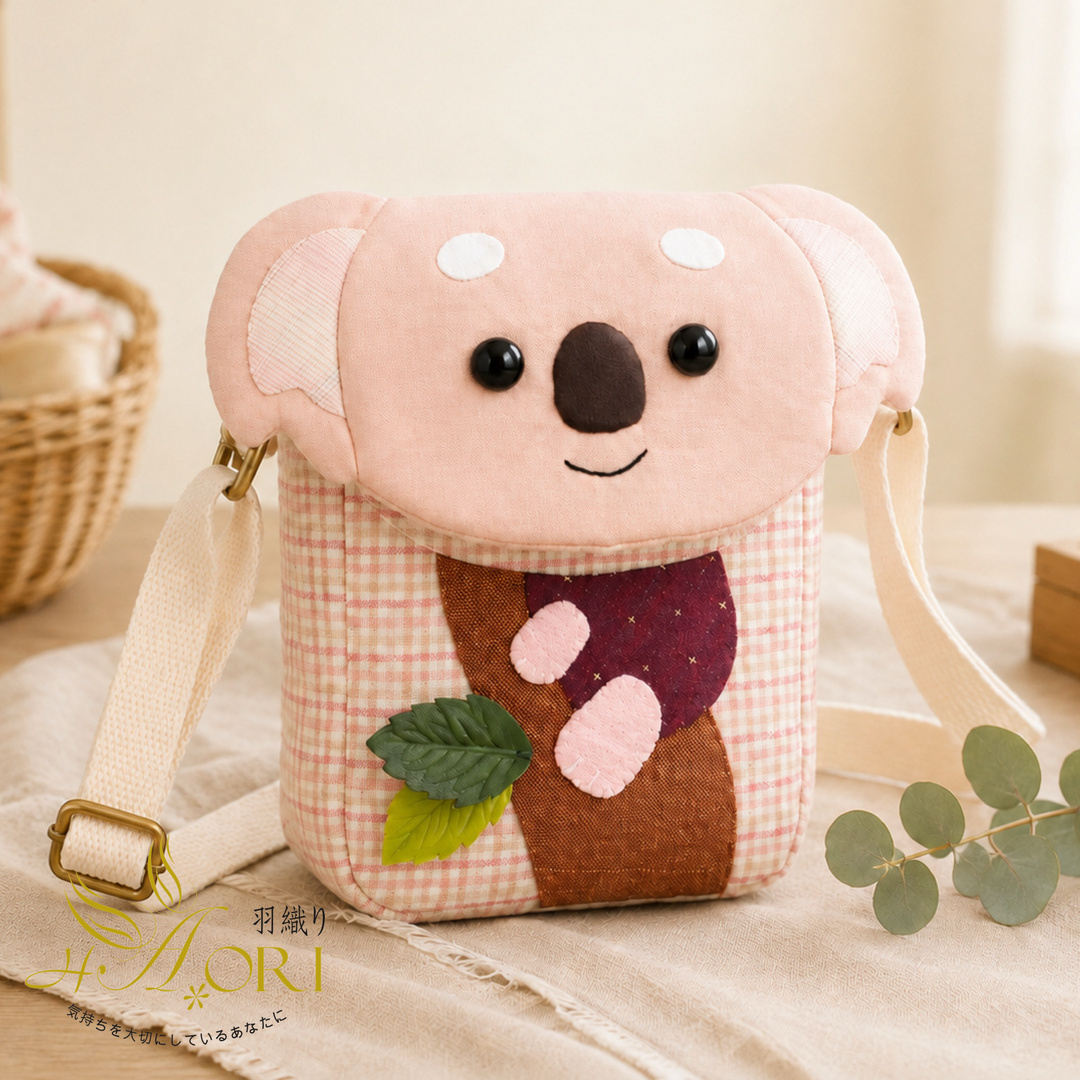 Front view of a finished pink checked koala crossbody bag