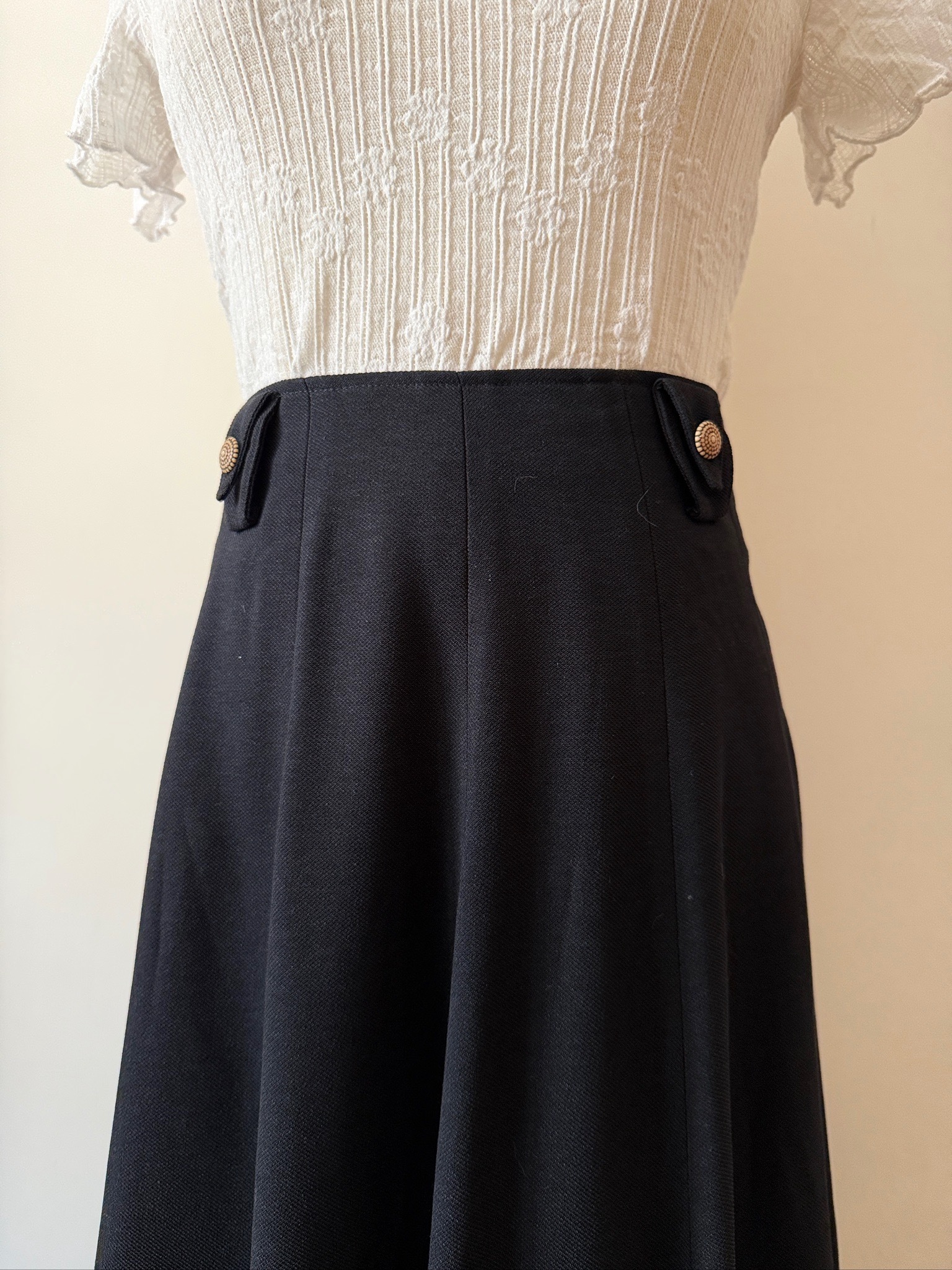 High-waisted black vintage skirt with wood-tone buttons