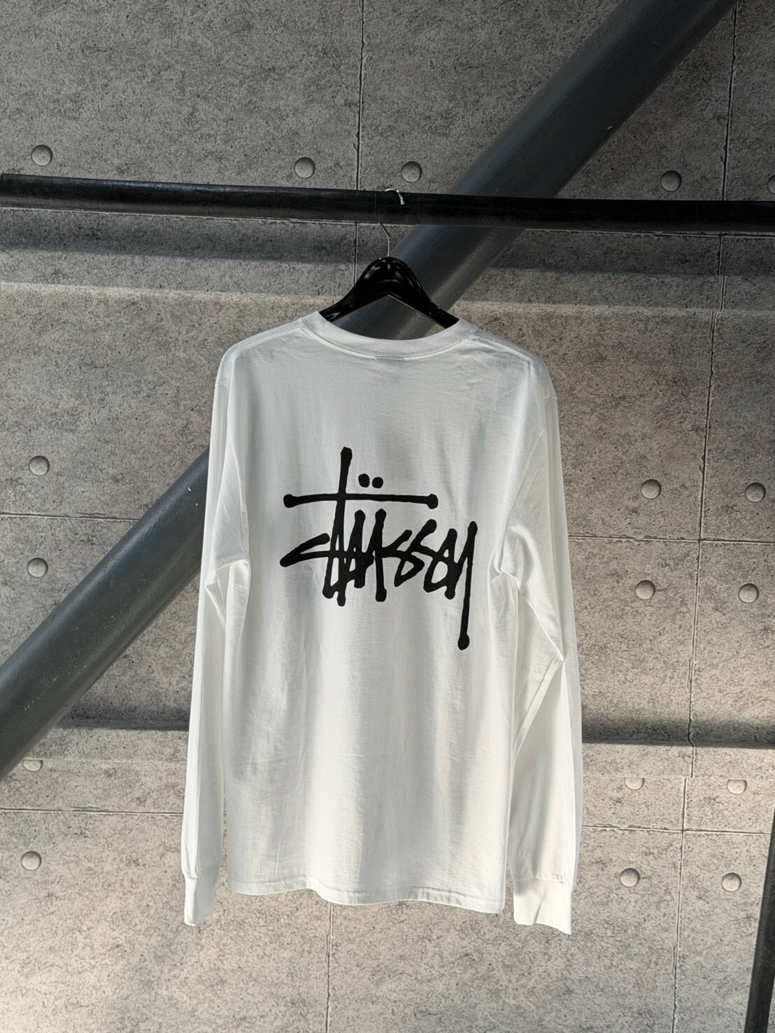 STUSSY classic style white long-sleeved T-shirt with large logo on the front and back.