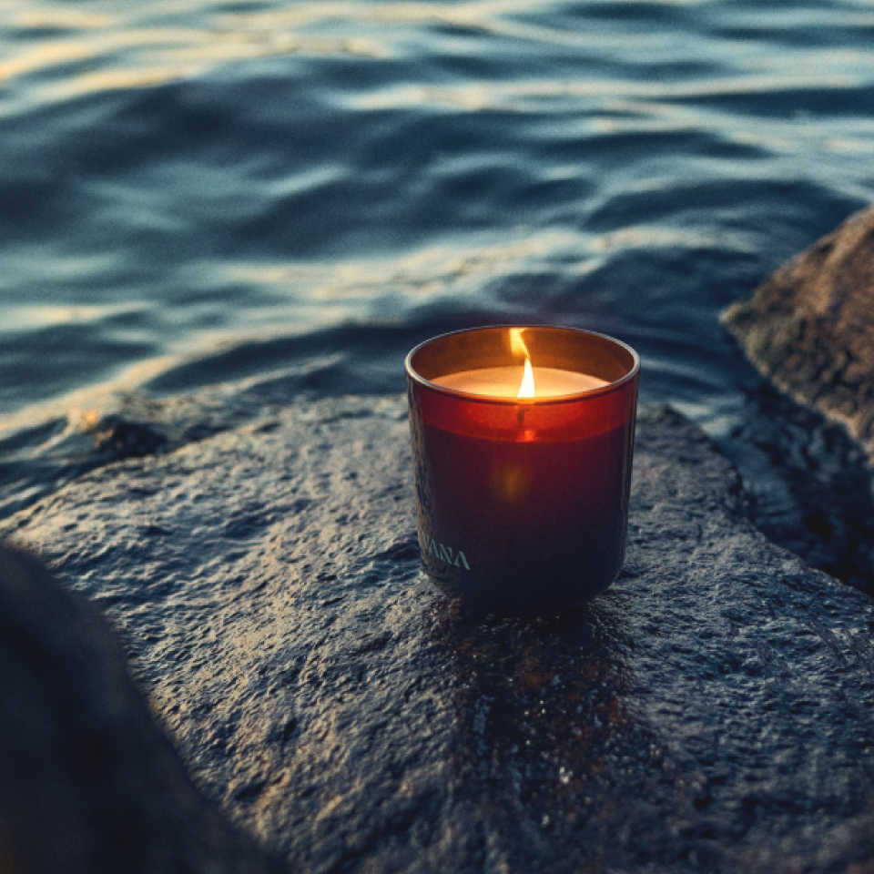 VANA candle beside Scandinavian water