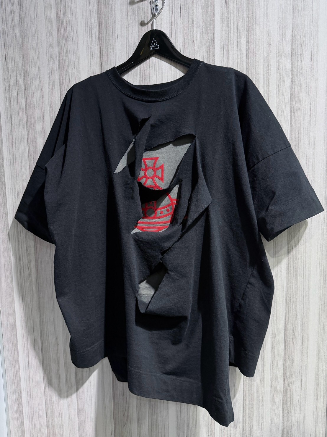 50% off Vivienne Westwood deconstructed two-piece set: a black and gray short-sleeved shirt with a large Saturn logo and a vest.