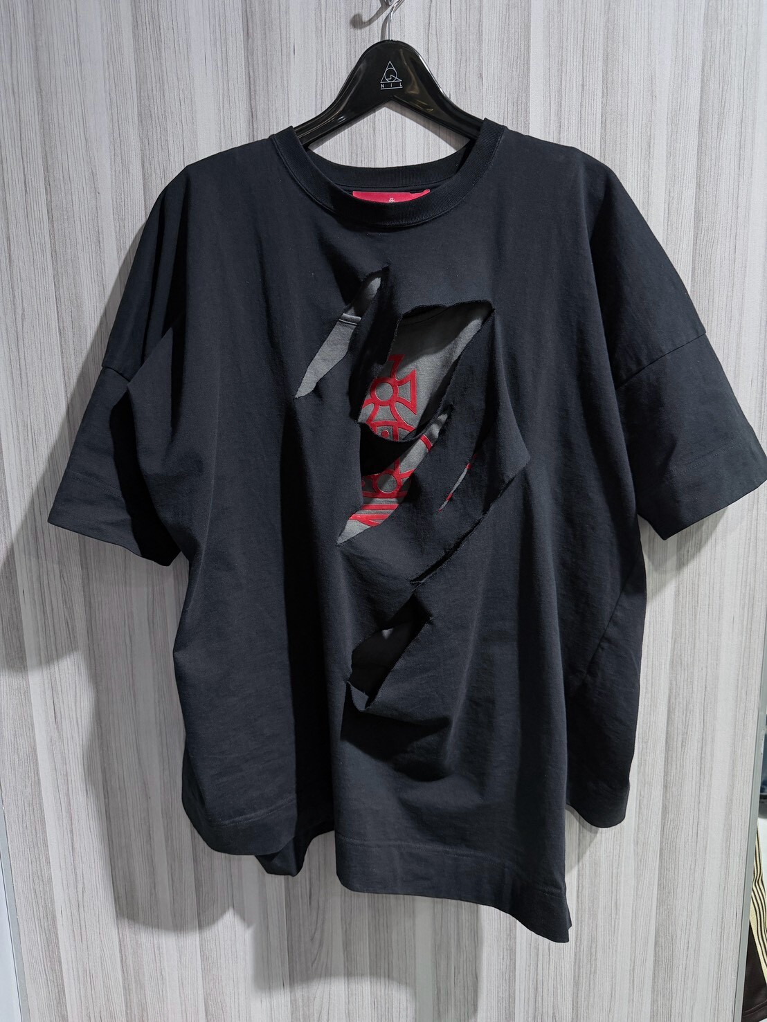 50% off Vivienne Westwood deconstructed two-piece set: a black and gray short-sleeved shirt with a large Saturn logo and a vest.