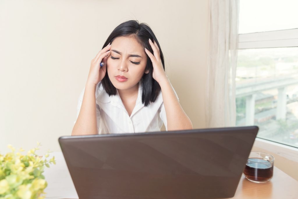 portrait depressed female entrepreneur sitting front computer while working