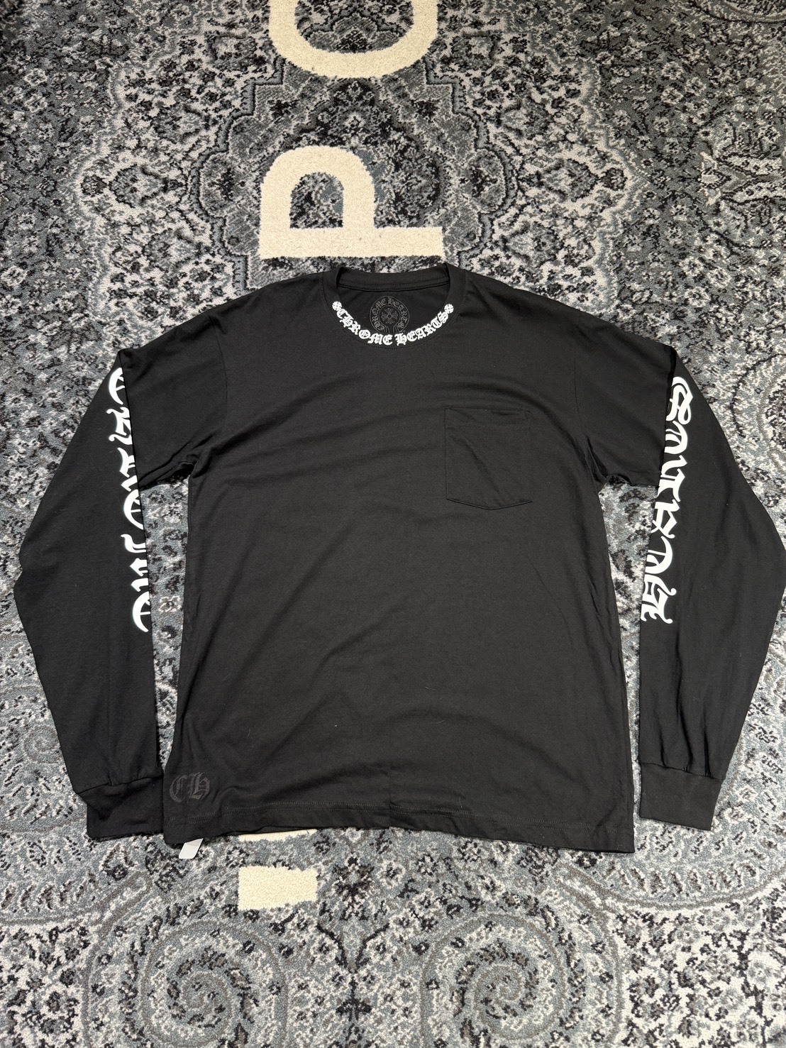 Chrome Hearts classic black and white long-sleeved shirt with Sanskrit lettering on the neck and arms.
