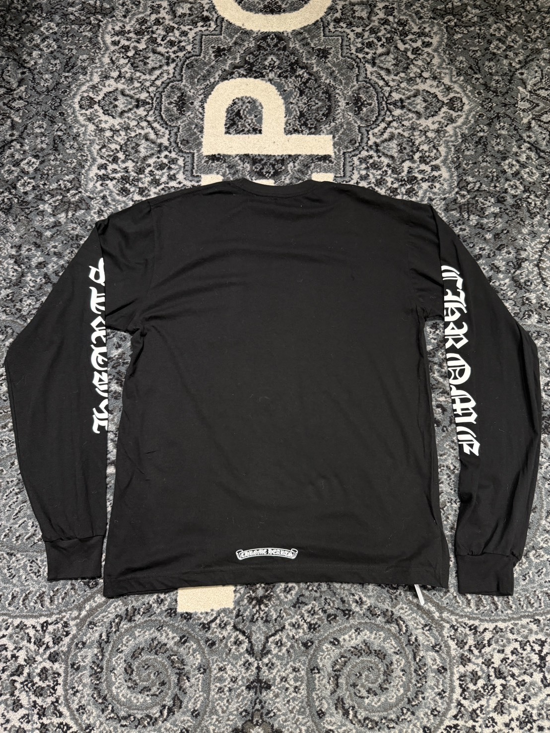 Chrome Hearts classic black and white long-sleeved shirt with Sanskrit lettering on the neck and arms.