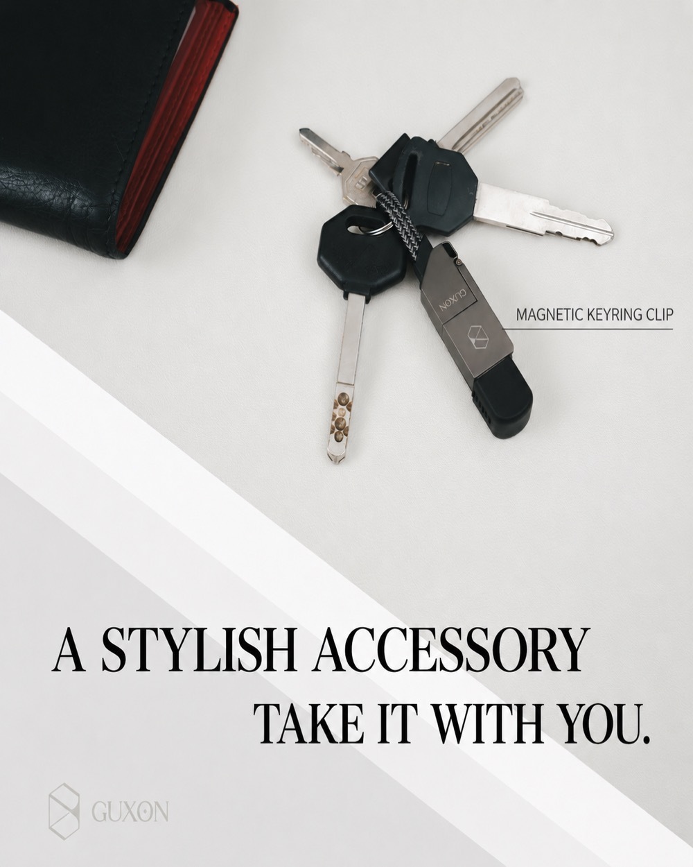 Magnetic keyring clip attached to a set of keys beside a wallet