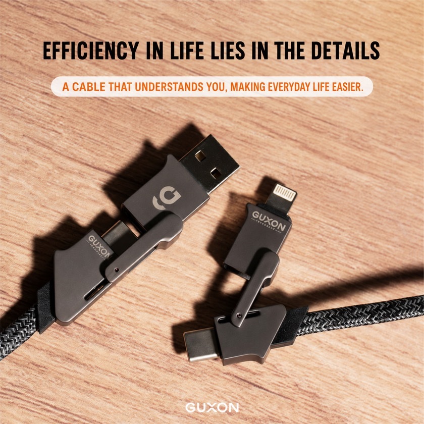 GUXON 4-in-1 zinc alloy cable laid on a wooden desk, braided and detailed finish