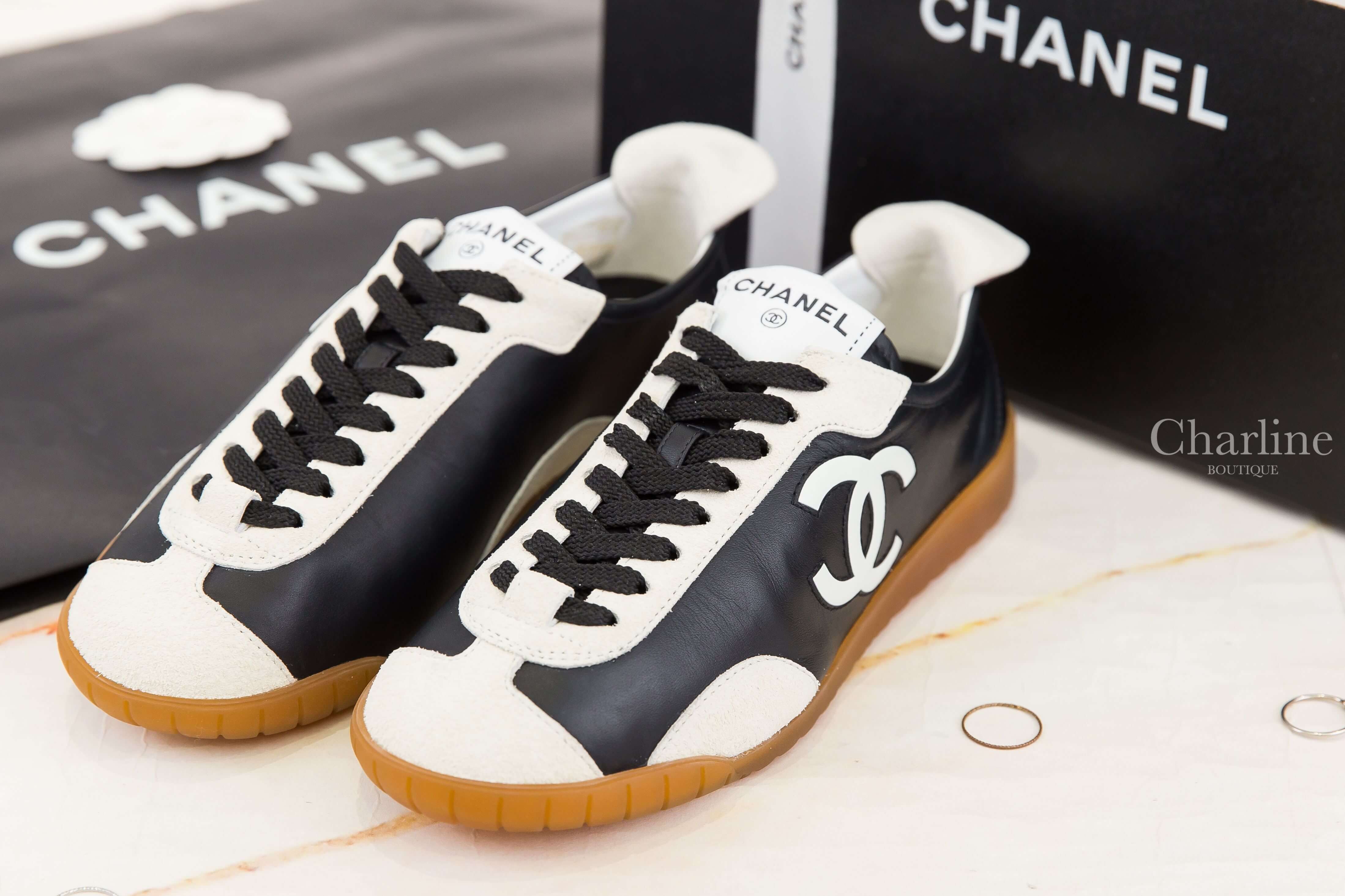Chanel Trainers 黑色牛皮拼白色麂皮側邊白CC焦糖色鞋底白尾運動鞋 雙鞋側前方角度與白色雙C Logo展示